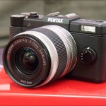 Black Pentax Q mini system camera and 5-15mm zoom lens