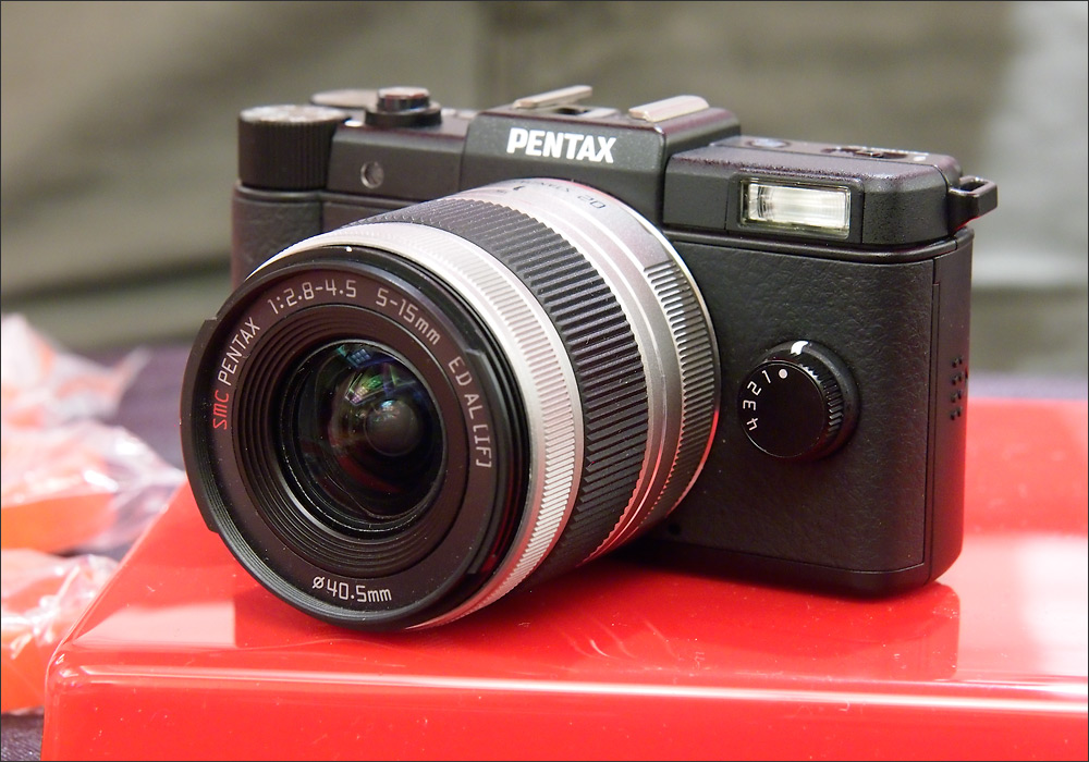 Black Pentax Q mini system camera and 5-15mm zoom lens