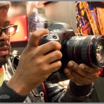 PhotoPlus Expo attendee checking out the new EOS-1D X in the Canon booth