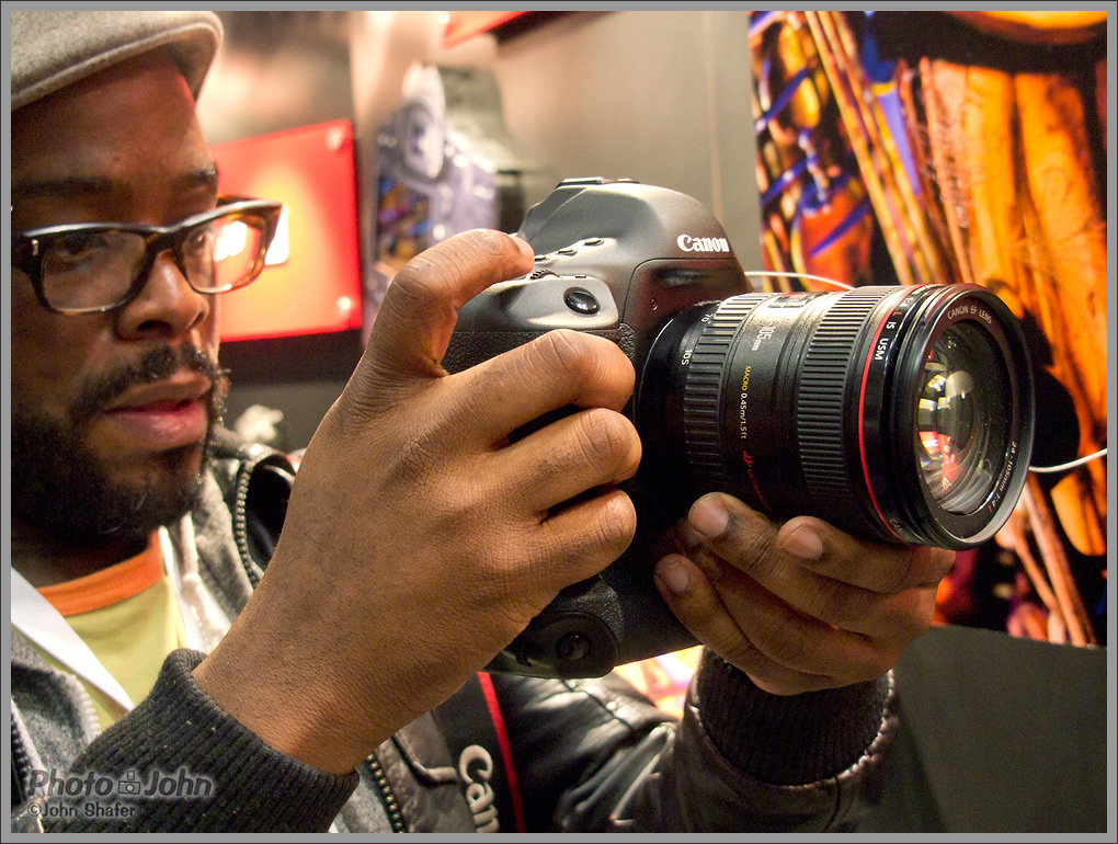 PhotoPlus Expo attendee checking out the new EOS-1D X in the Canon booth